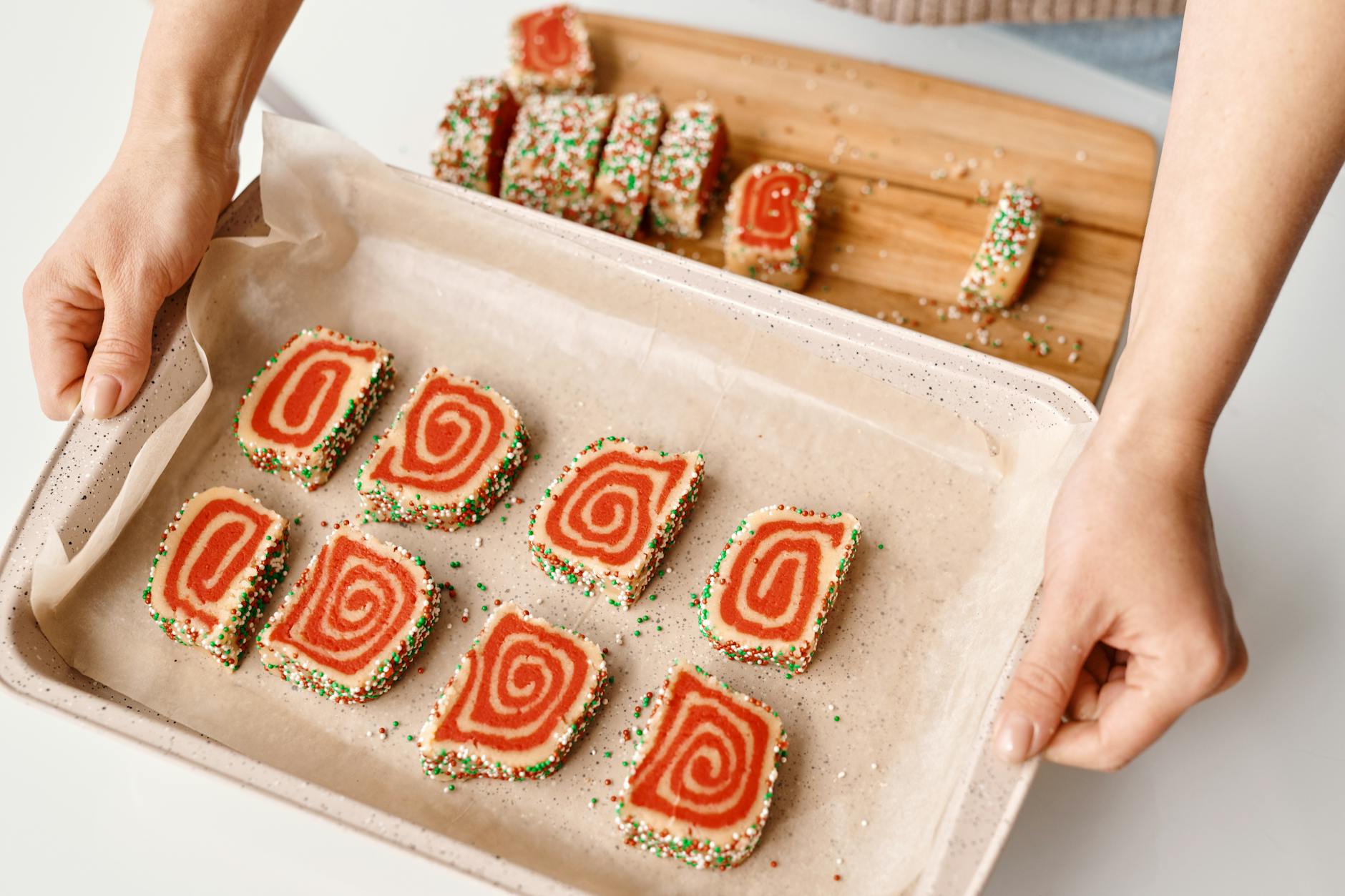 person holding a tray with sliced cakes