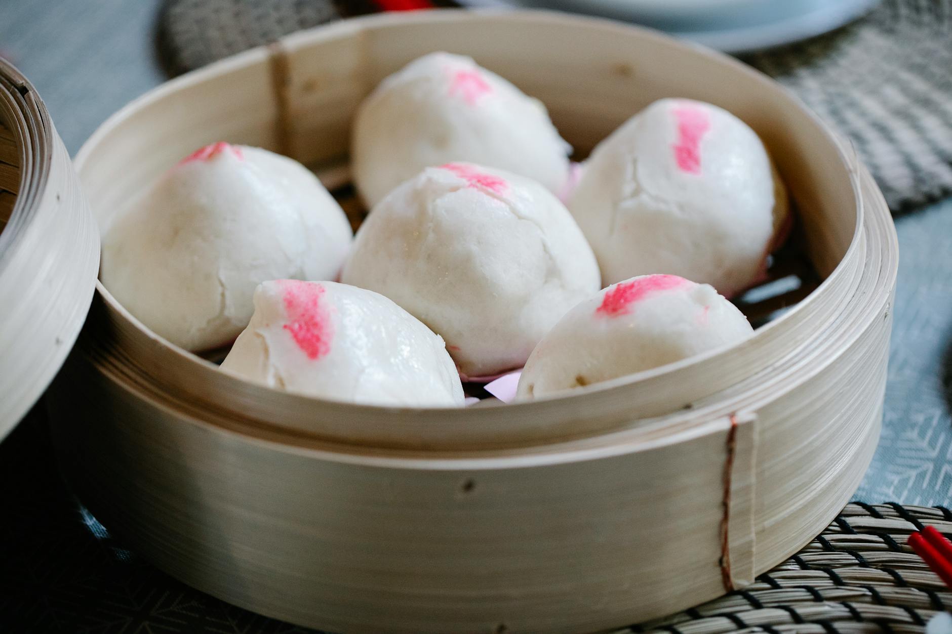 yeast leavened filled bun in bamboo steamer