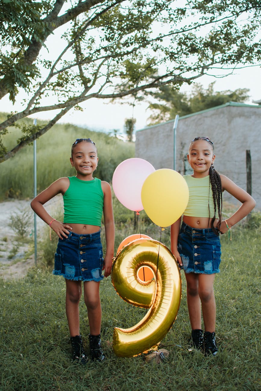 smiling girls with birthday balloons